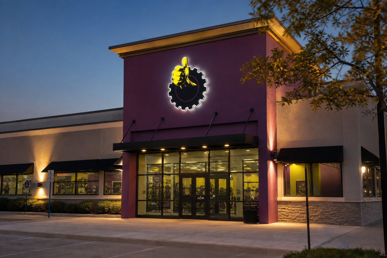 Planet Fitness open storefront at dusk with illuminated entrance
